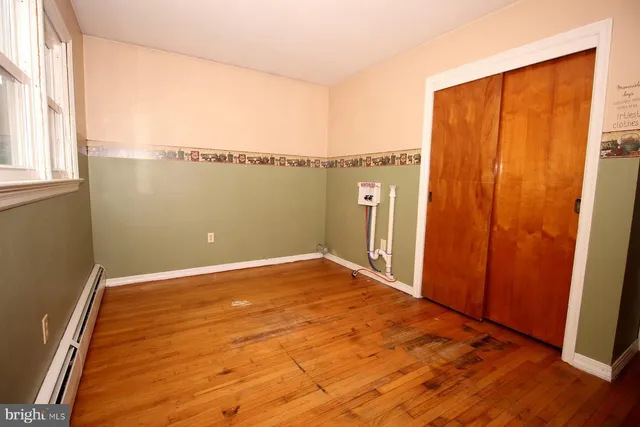a view of a room with window and wooden floor