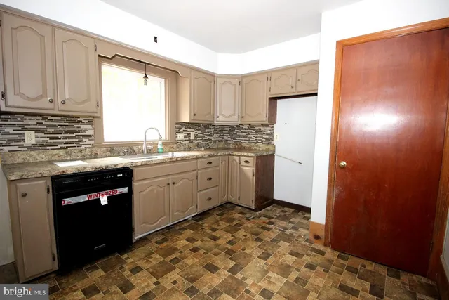 a kitchen with a sink stove and refrigerator