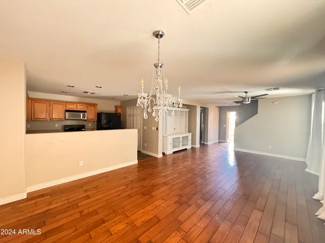 a view of a room with wooden floor