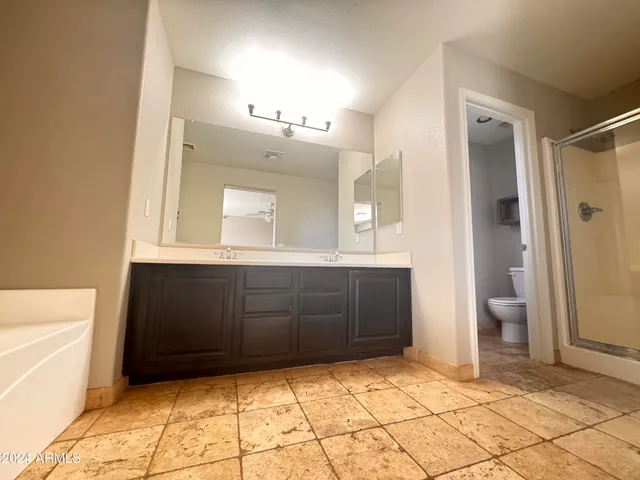 a view of a bathroom with a sink and a mirror