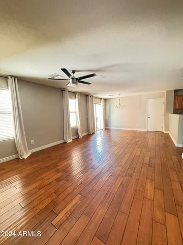 a view of a room with wooden floor