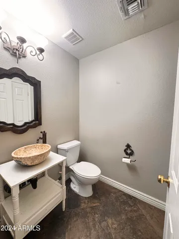a bathroom with a toilet a sink and a mirror
