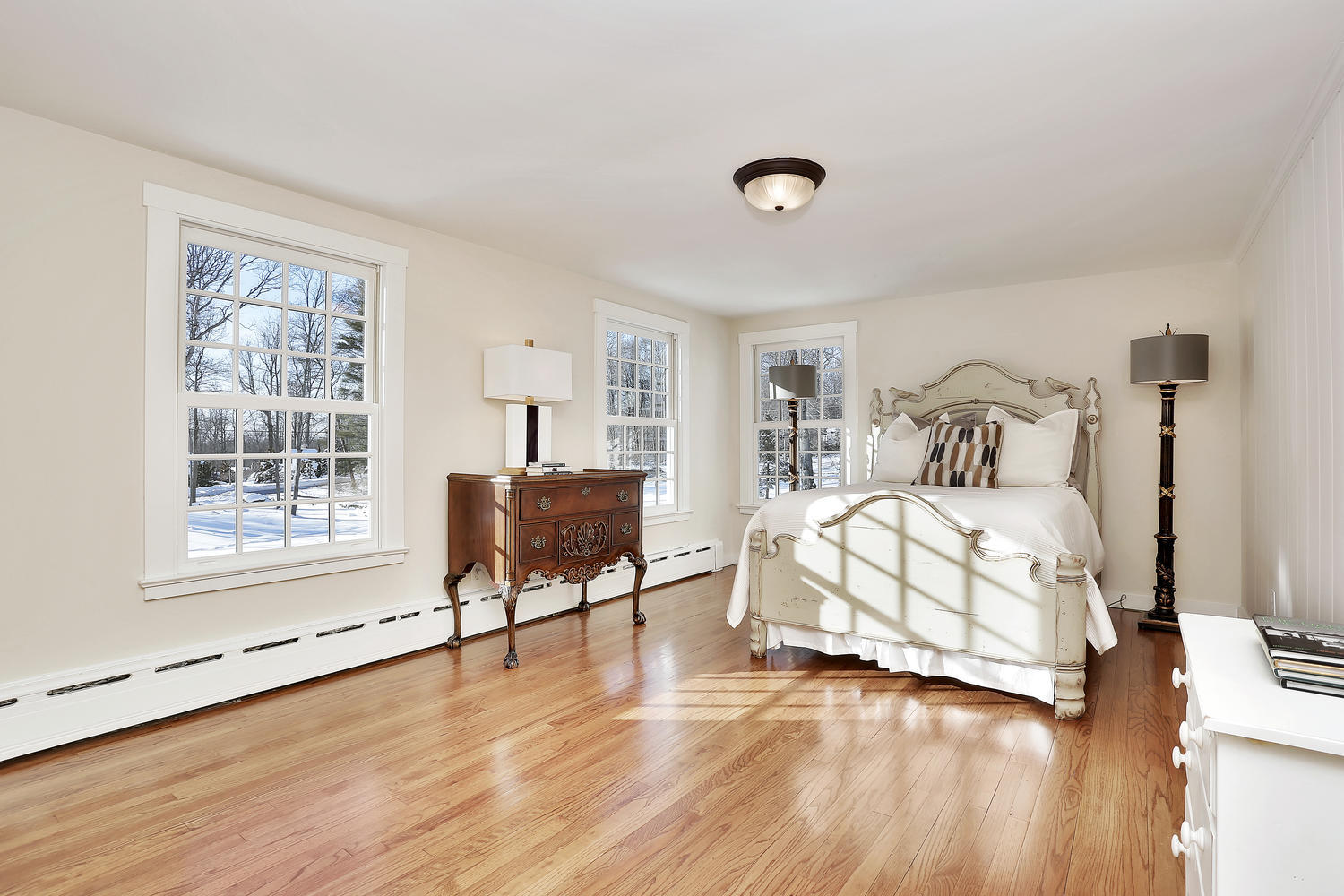 231 Turtle Back Road New Canaan, CT 06840 - Photo 15 of 22 a bedroom with a bed and wooden floor