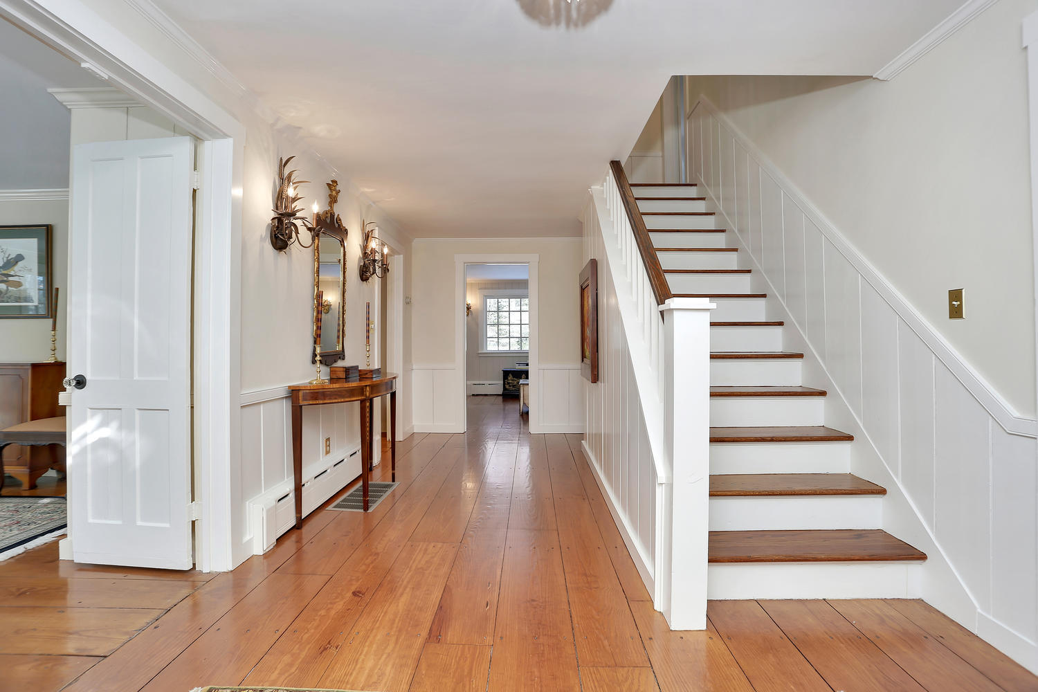 231 Turtle Back Road New Canaan, CT 06840 - Photo 19 of 22 a view of a hallway with wooden floor and staircase