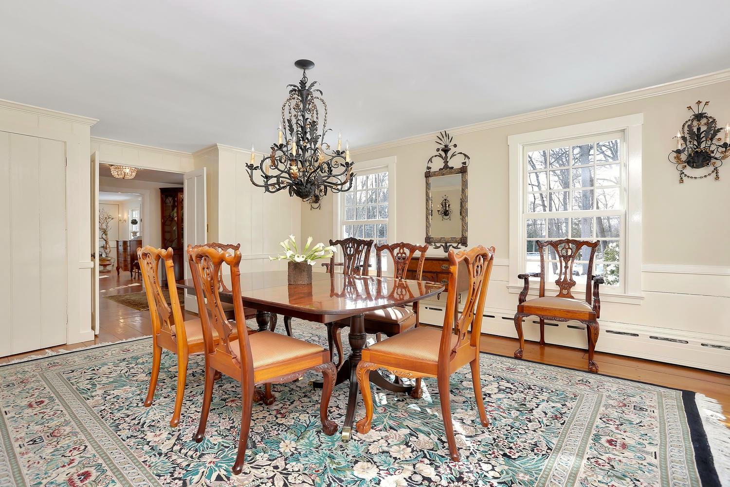 231 Turtle Back Road New Canaan, CT 06840 - Photo 9 of 22 a dining room with furniture a rug and a chandelier