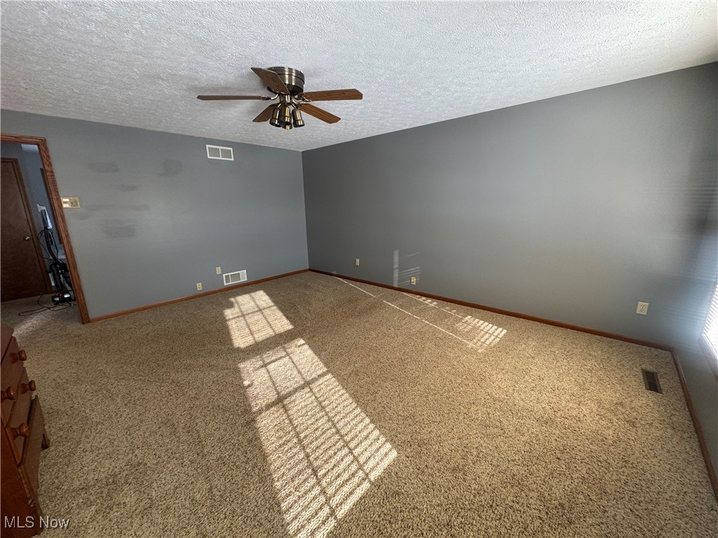 3530 State Road Medina, OH 44256 - Photo 22 of 47 Carpeted spare room with visible vents and a textured ceiling