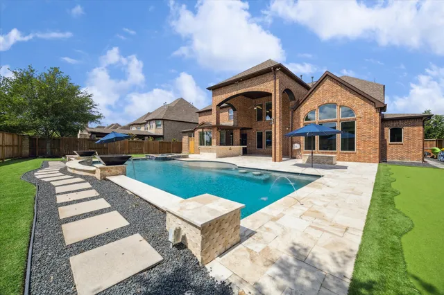 a view of house with outdoor space and swimming pool