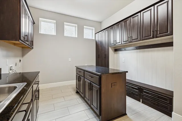 a kitchen with stainless steel appliances granite countertop a stove and a sink