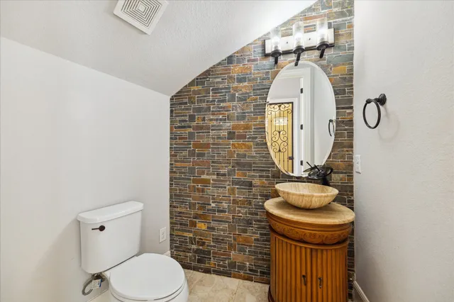 a bathroom with a toilet and a mirror