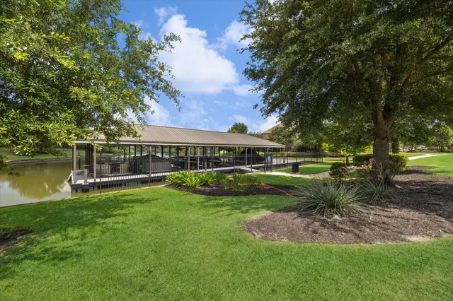 a view of a house with swimming pool and a yard