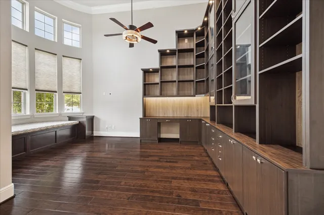 a view of an empty room with furniture and window