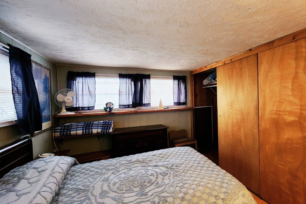 3040 Cranberry Highway, Unit 34 Wareham, MA 02538 - Photo 8 of 14 a room with a bed and a window