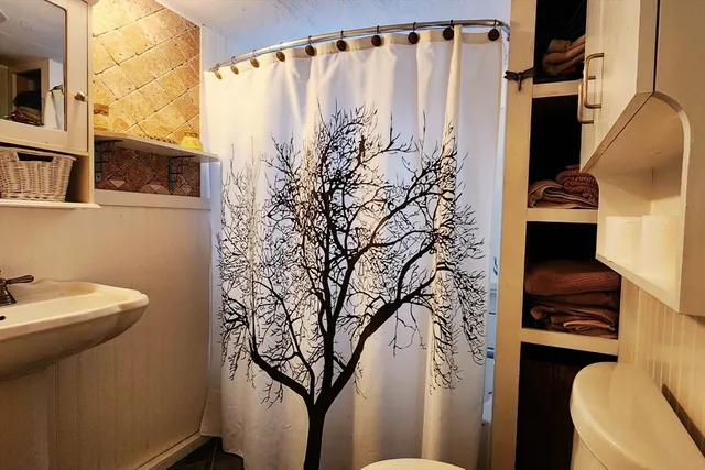 a bathroom with a toilet sink and tub