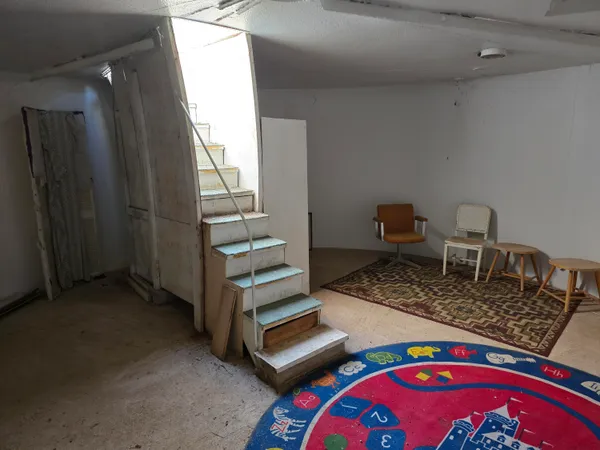 a front view of a house with chair and tables