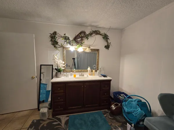 a living room with furniture a flat screen tv and a window