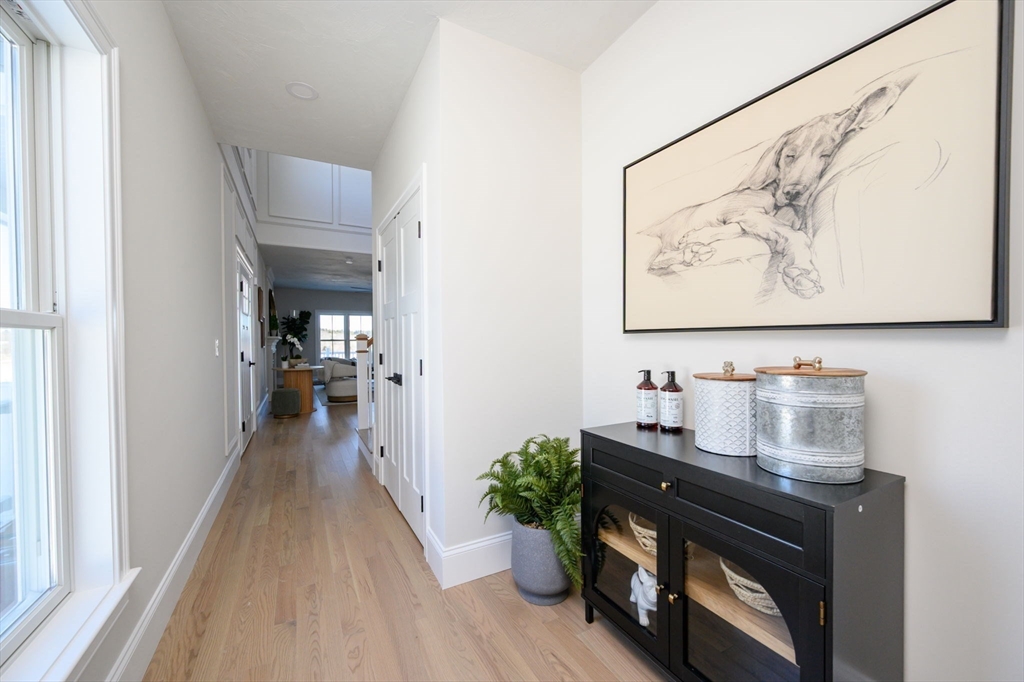 78 Metacomet Road, Unit 78 West Bridgewater, MA 02379 - Photo 23 of 39 a hallway with painting on the wall and a window