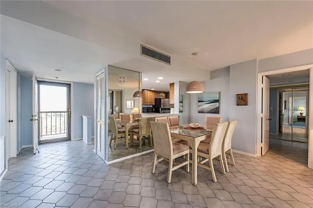 a dining room with furniture and a kitchen view