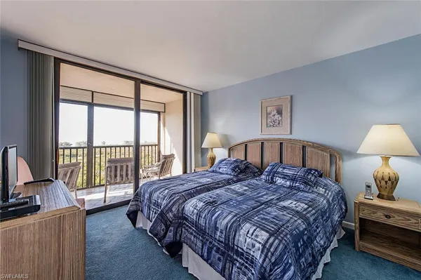 a bedroom with a large bed and a large window