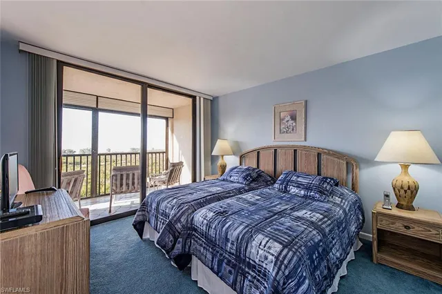 a bedroom with a large bed and a large window