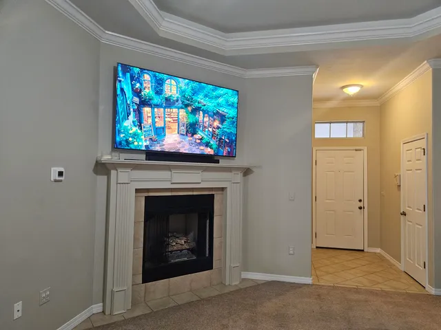 a view of an empty room with a fireplace and a bookshelf