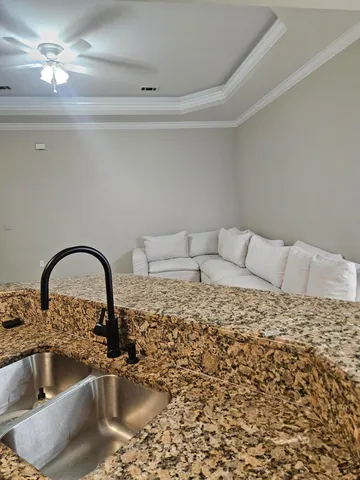 a close view of a sink a faucet and appliance in the kitchen