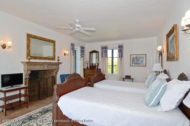 Undisclosed Address Palm Beach, FL 33480 - Photo 27 of 33 a bed room with a bed and a fireplace