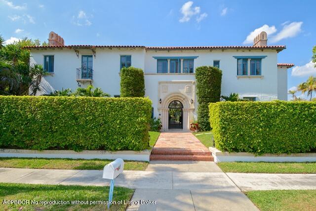 Undisclosed Address Palm Beach, FL 33480 - Photo 4 of 33 a front view of a house with a yard