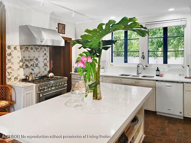 Undisclosed Address Palm Beach, FL 33480 - Photo 8 of 33 a kitchen with stainless steel appliances granite countertop a stove a sink a microwave a refrigerator and a white cabinets