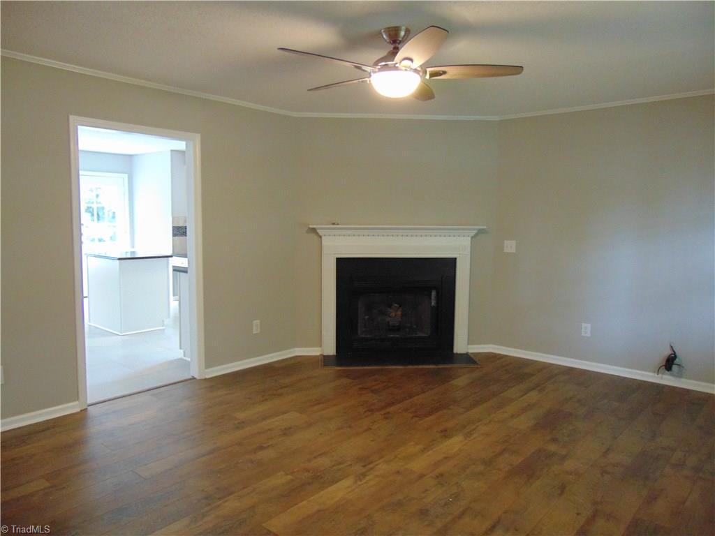 6819 Rangecrest Road Belews Creek, NC 27009 - Photo 2 of 30 As you enter the front door you'll experience the new handscraped laminate floors, new ceiling fan and gas log fireplace!