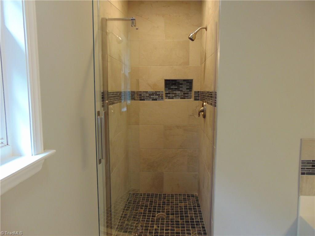6819 Rangecrest Road Belews Creek, NC 27009 - Photo 11 of 30 Custom tile is continued in master bath separate shower enclosure!