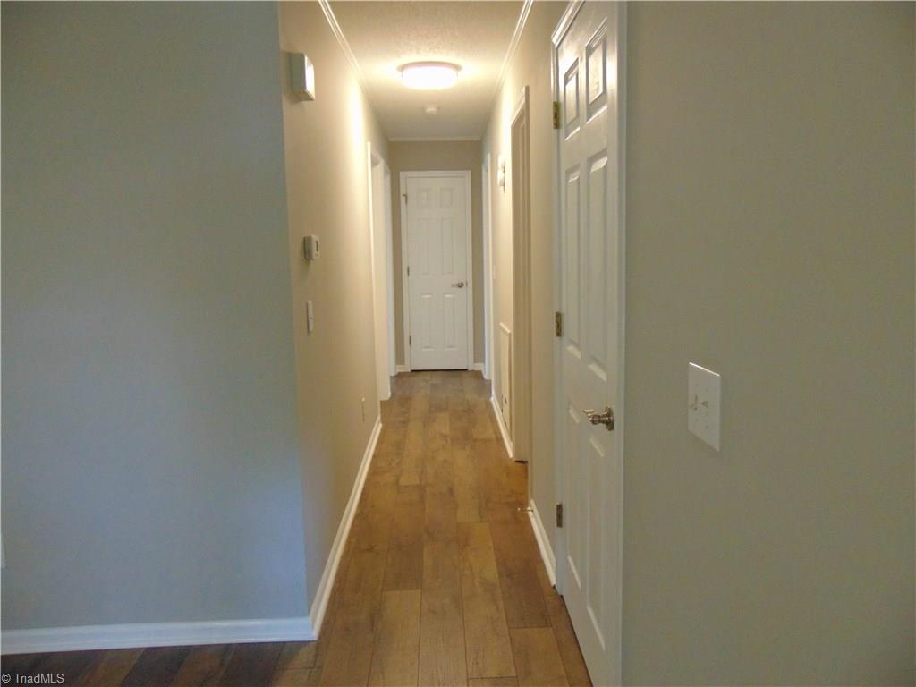6819 Rangecrest Road Belews Creek, NC 27009 - Photo 13 of 30 Wood laminate floors extend from living room down hall to bedrooms!