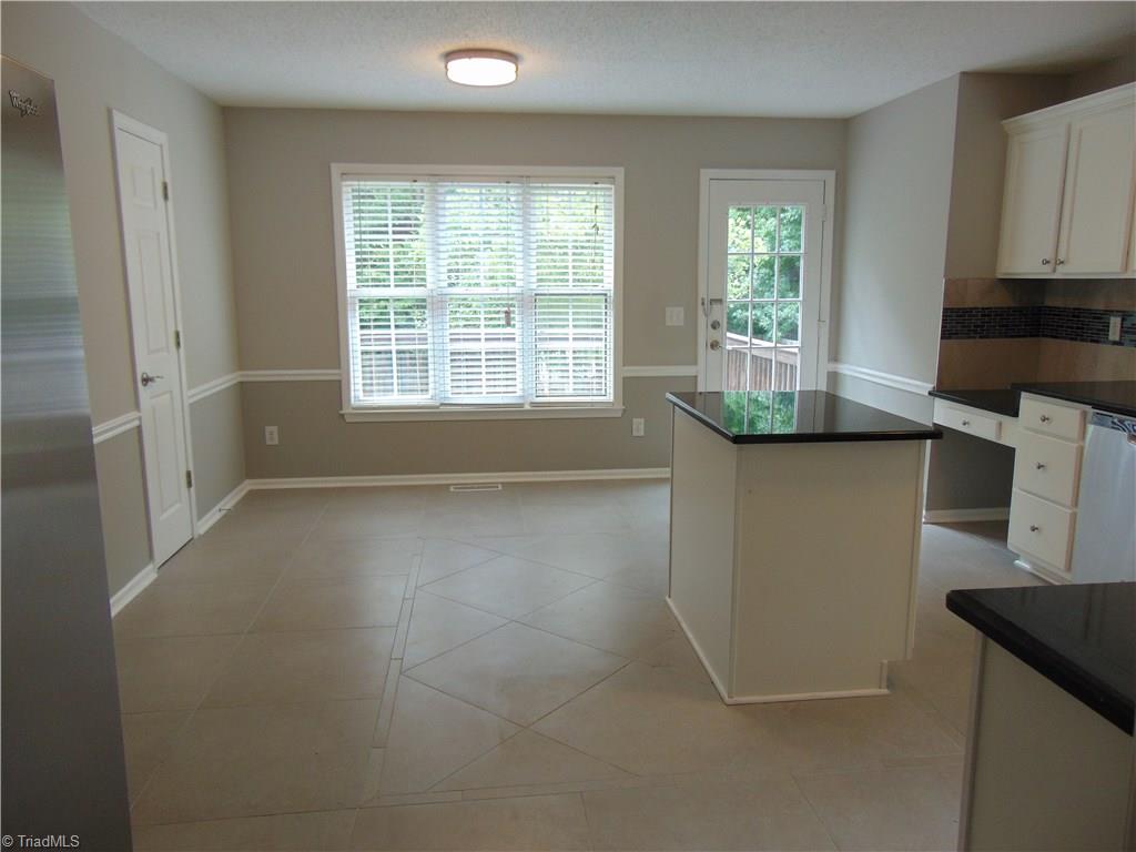 6819 Rangecrest Road Belews Creek, NC 27009 - Photo 14 of 30 View into kitchen from living room shows the size with room for your table and floor custom tile work!