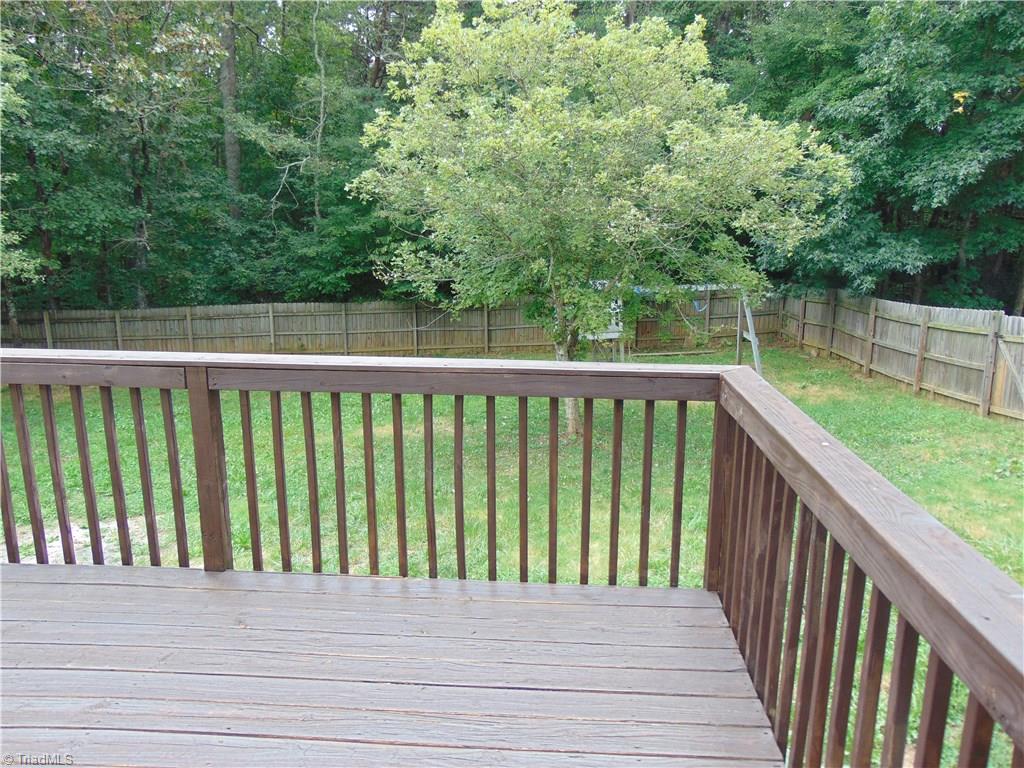 6819 Rangecrest Road Belews Creek, NC 27009 - Photo 15 of 30 Back yard deck looks out onto spacious back yard with privacy fence!