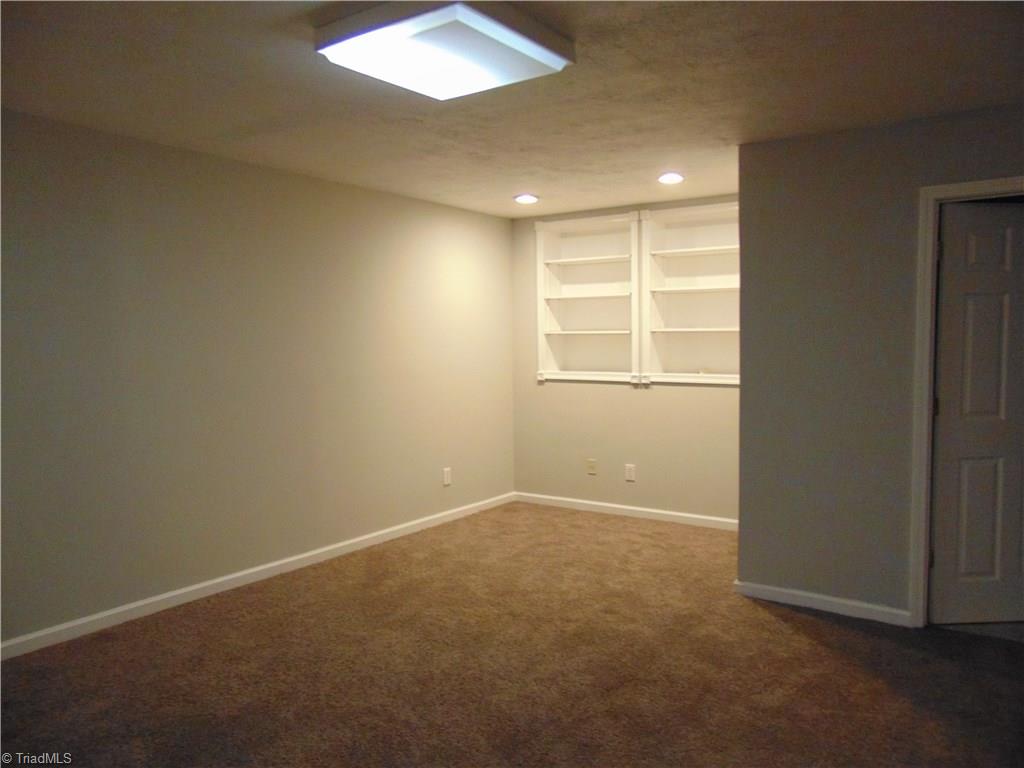 6819 Rangecrest Road Belews Creek, NC 27009 - Photo 23 of 30 Downstairs bonus room has built-in shelves. Great space for kids, movies or inlaws!