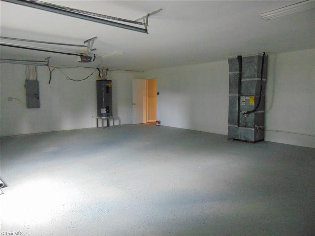 6819 Rangecrest Road Belews Creek, NC 27009 - Photo 27 of 30 Another view of large garage with painted floors has space for cars, washer, dryer and more!
