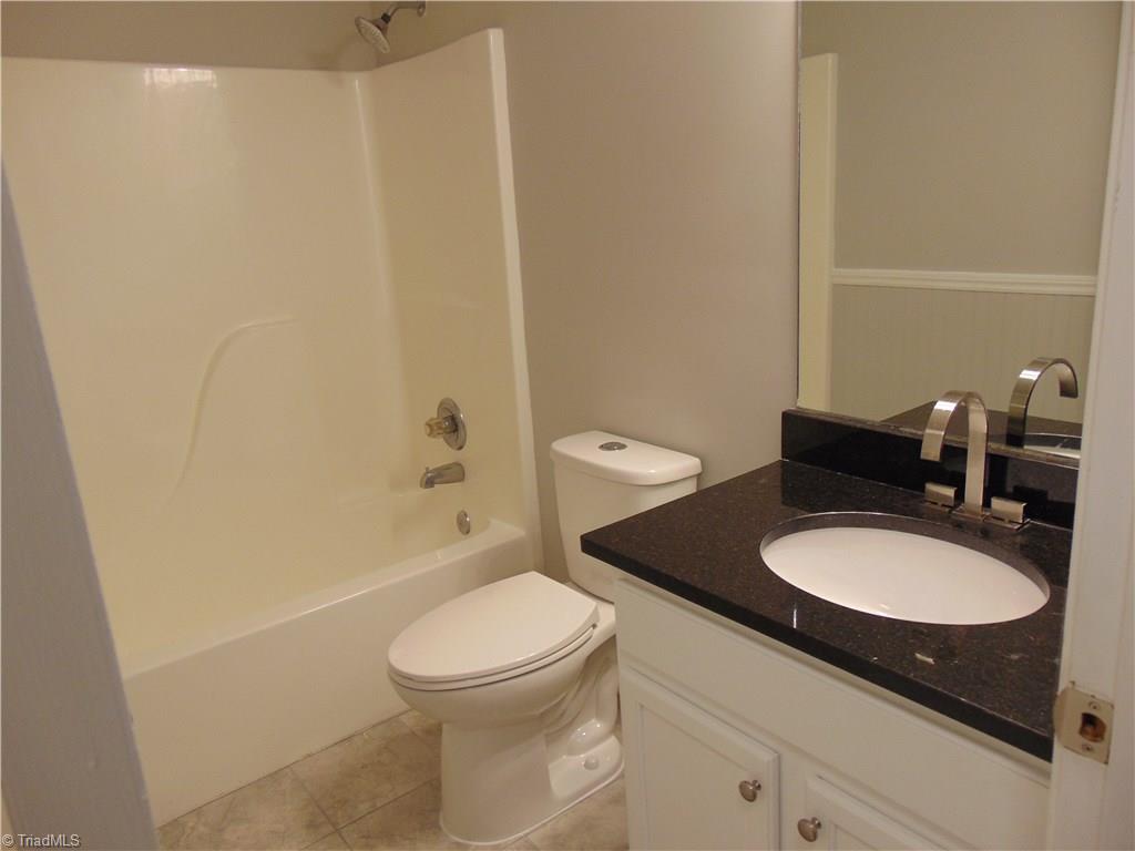 6819 Rangecrest Road Belews Creek, NC 27009 - Photo 7 of 30 Hallway bath has same granite and cabinetry as kitchen!