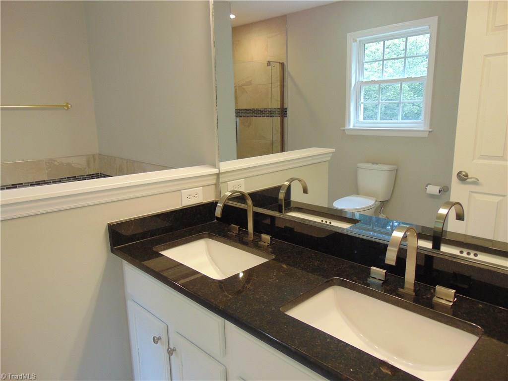 6819 Rangecrest Road Belews Creek, NC 27009 - Photo 8 of 30 Granite is continued to master bathroom. Look at the modern faucets!