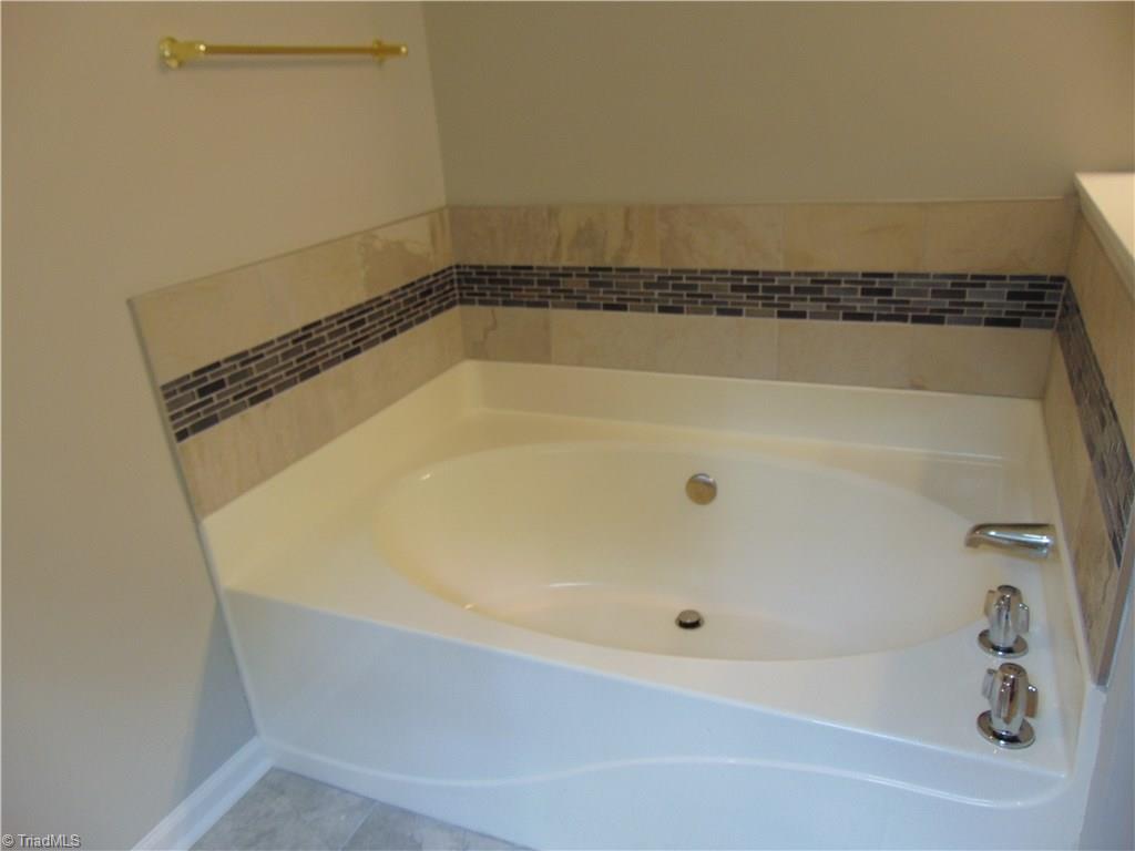 6819 Rangecrest Road Belews Creek, NC 27009 - Photo 10 of 30 Custom tile work from kitchen has been continued in master bath for garden tub surround!
