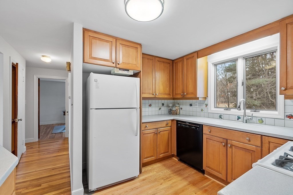 207 Peter Spring Road Concord, MA 01742 - Photo 8 of 30 a kitchen with a sink refrigerator and window