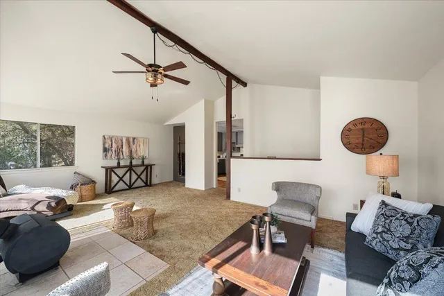 a living room with furniture and a kitchen