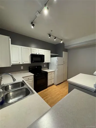 a kitchen with stainless steel appliances a refrigerator stove microwave and sink