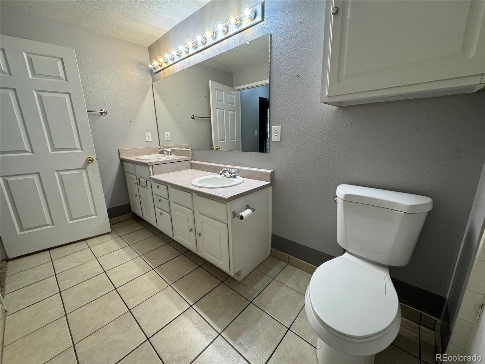 1815 Spaulding Circle Superior, CO 80027 - Photo 16 of 24 a bathroom with a toilet sink and mirror