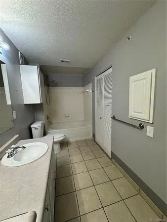 a view of an empty room with a ceiling fan