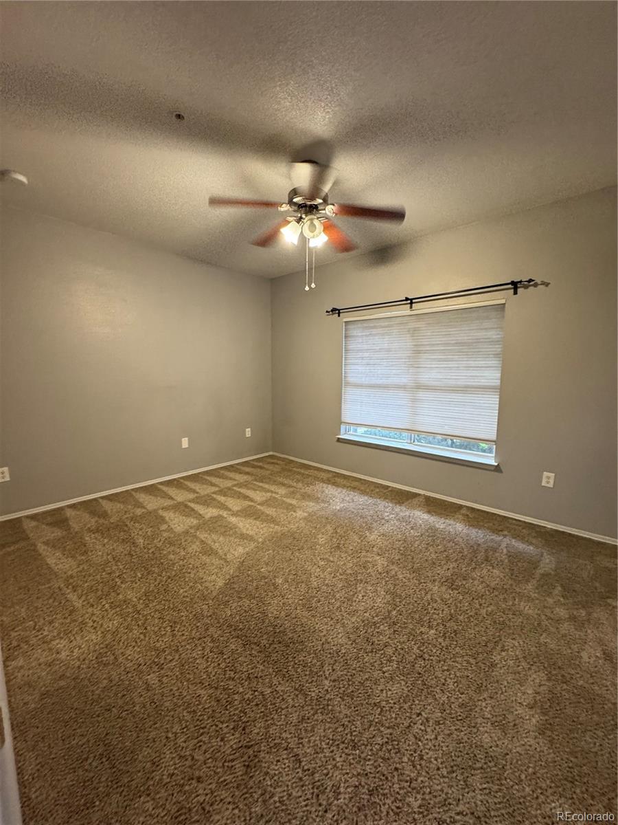 1815 Spaulding Circle Superior, CO 80027 - Photo 19 of 24 a view of an empty room with a ceiling fan