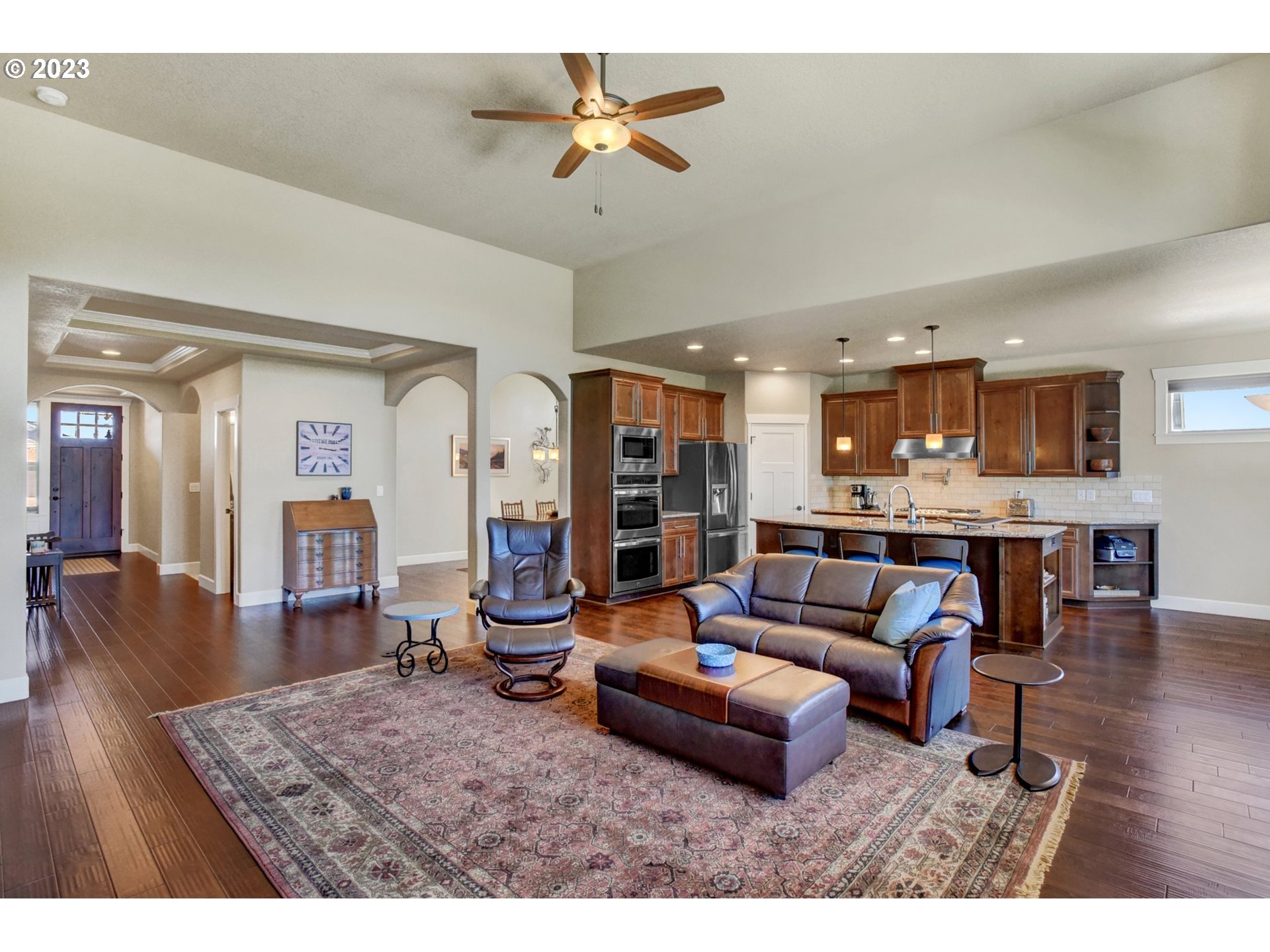 1710 South Nighthawk Road Ridgefield, WA 98642 - Photo 8 of 44 a living room with furniture kitchen view and a wooden floor