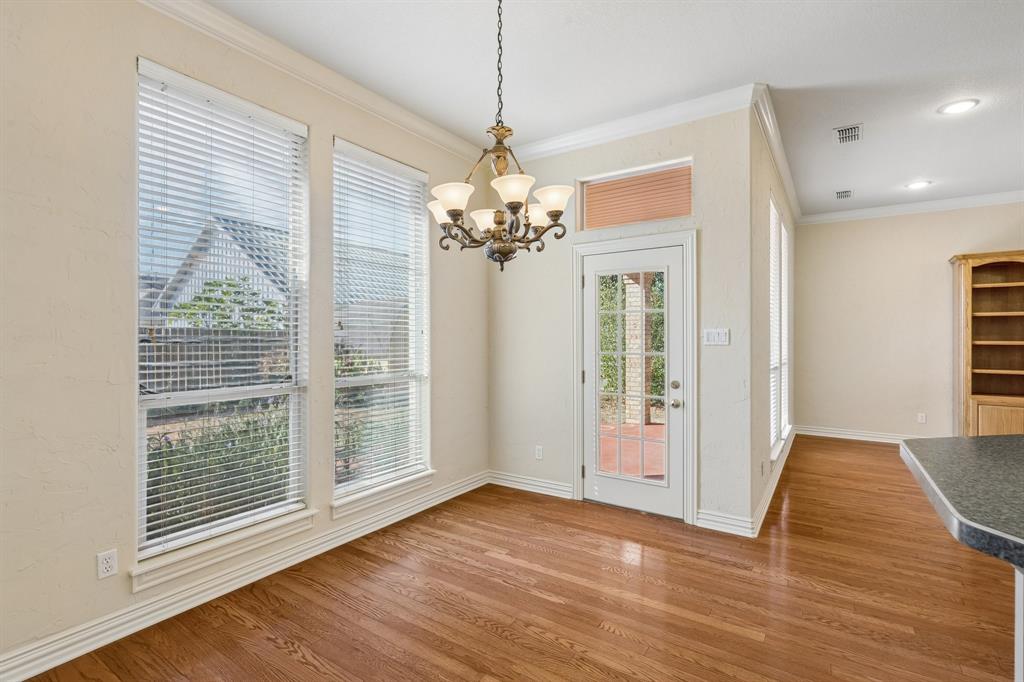 1727 Ridgecrest Drive Cleburne, TX 76033 - Photo 13 of 32 Wood-finish flooring, multiple windows, glass-paneled exterior door with transom, decorative chandelier, and recessed lighting