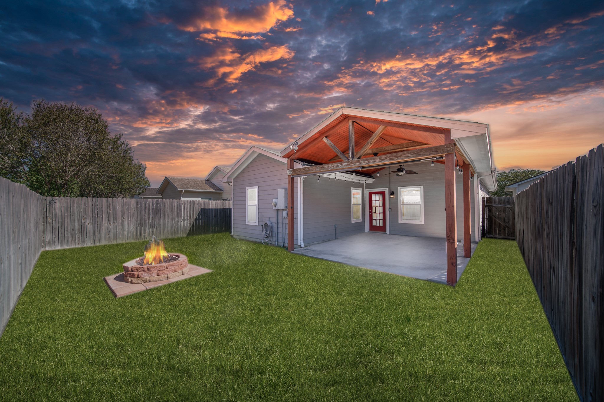 a backyard of a house with table and chairs