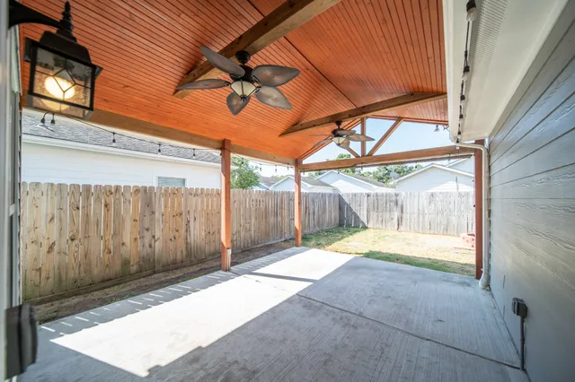 a view of a backyard with wooden fence