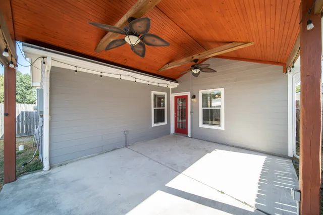 a view of backyard with swimming pool and seating