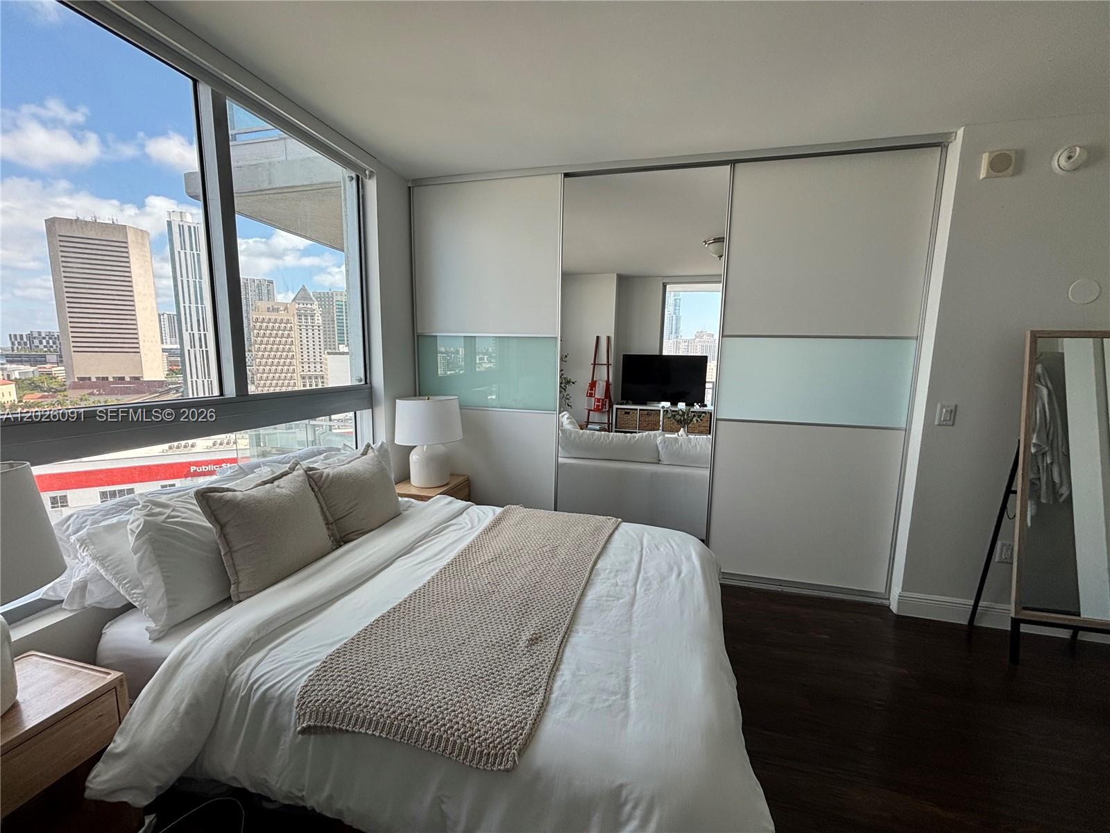 90 Southwest 3rd Street, Unit 1705 Miami, FL 33130 - Photo 7 of 33 a bedroom with a bed and a large window